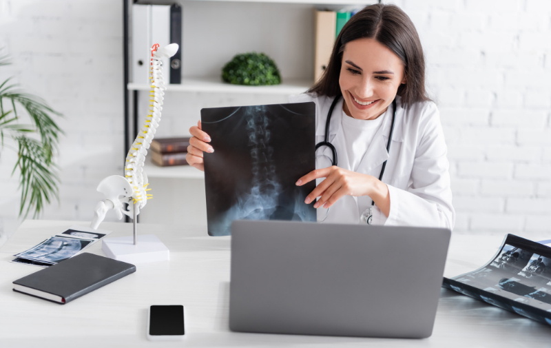 orthopedic 3 Clinician showing a spinal X-ray during an online consultation